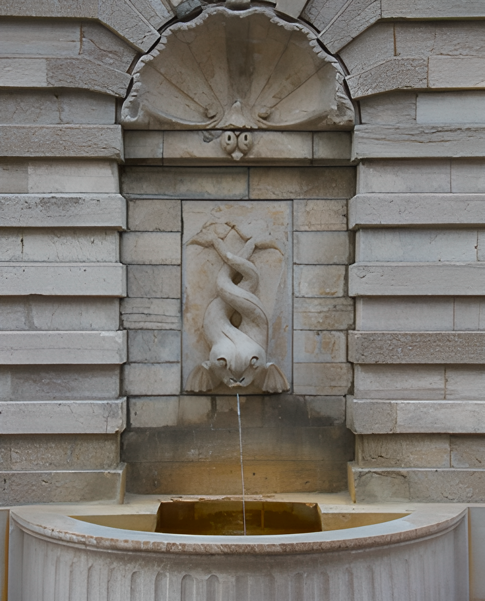 An outdoor concrete fountain with fitted pump