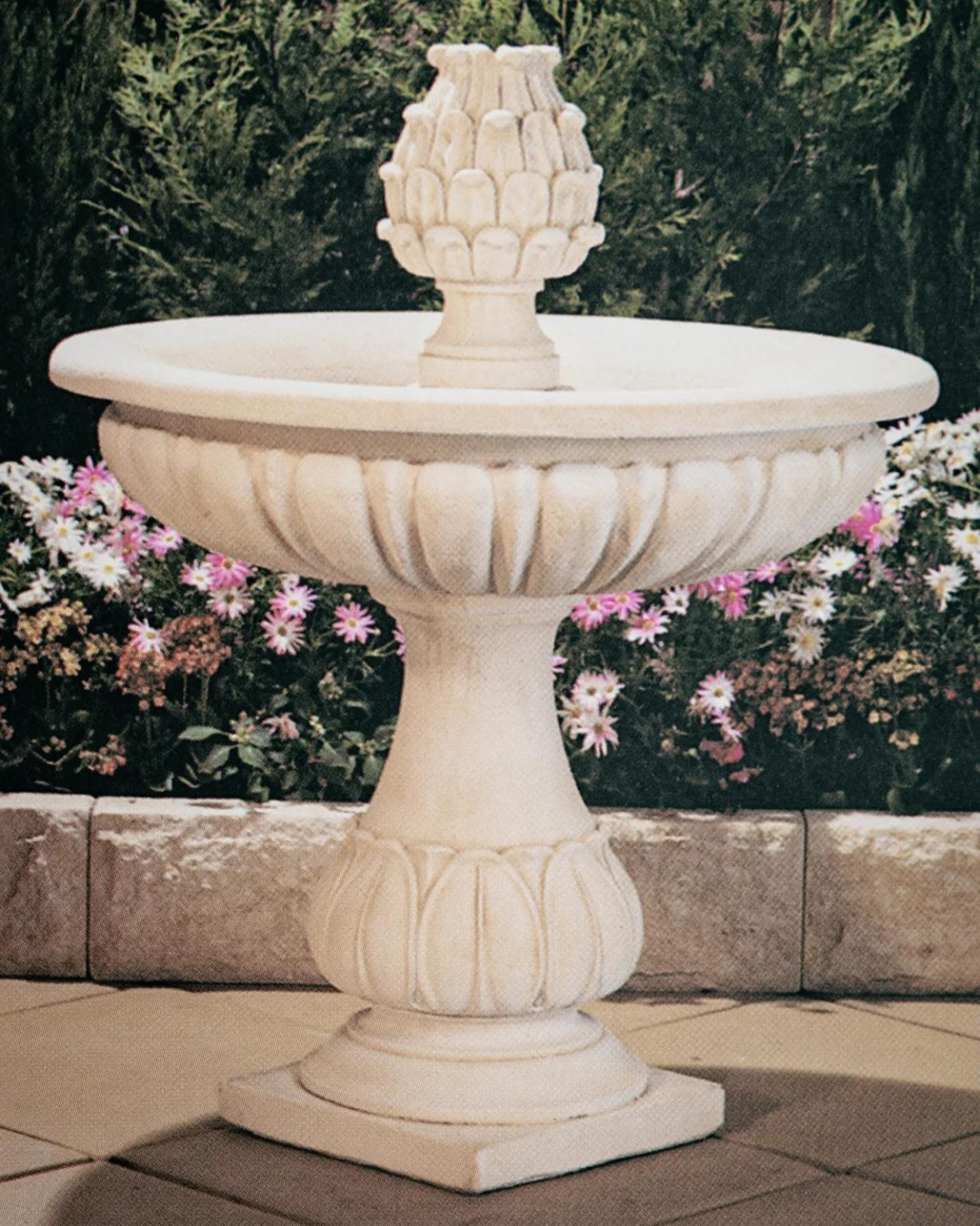 1 tier water feature with a garden backdrop