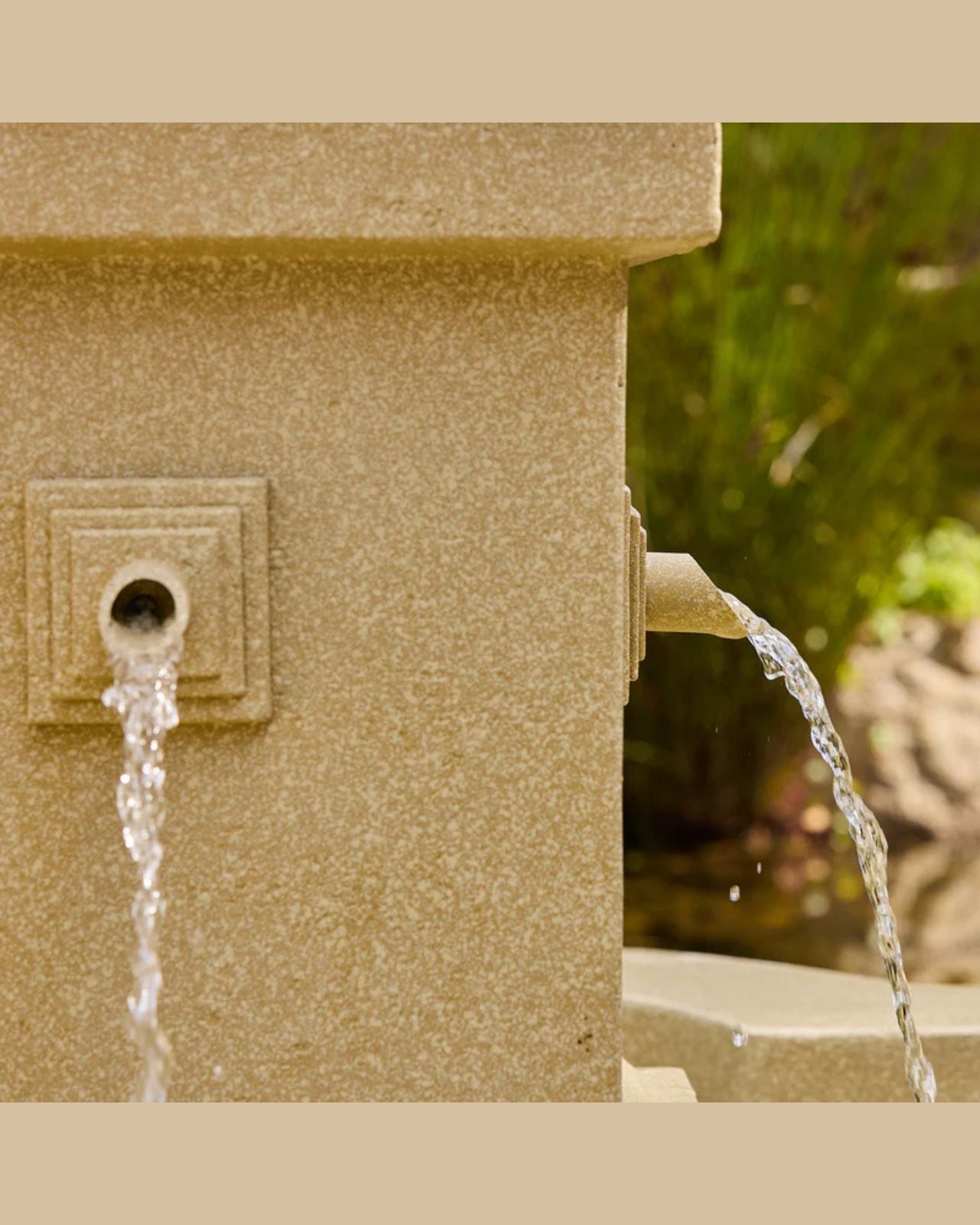 Stone water fountain with water flowing out, set against a natural background.