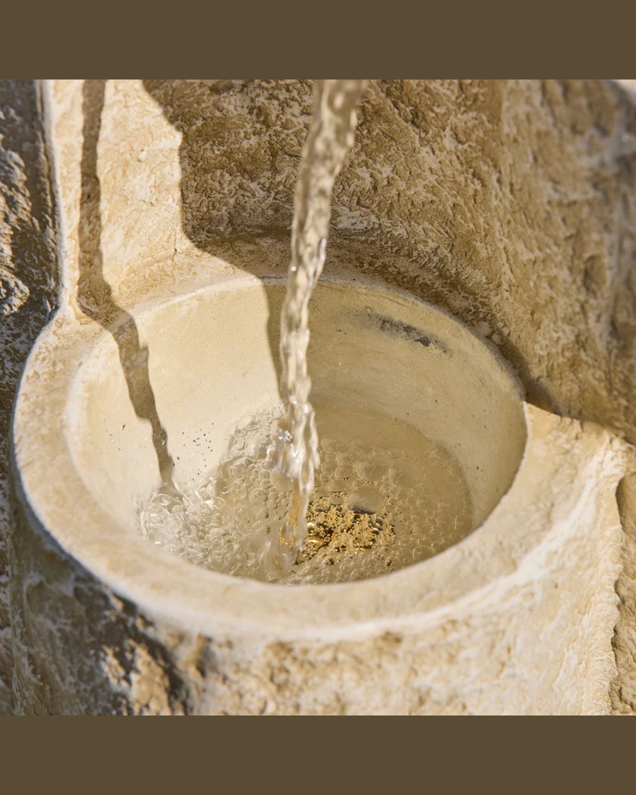 Close-up of Echo Falls fountain with water flowing into a basin.