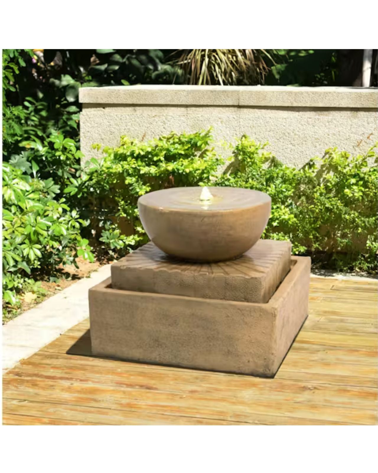 Decorative outdoor fountain with a bowl on a wooden deck