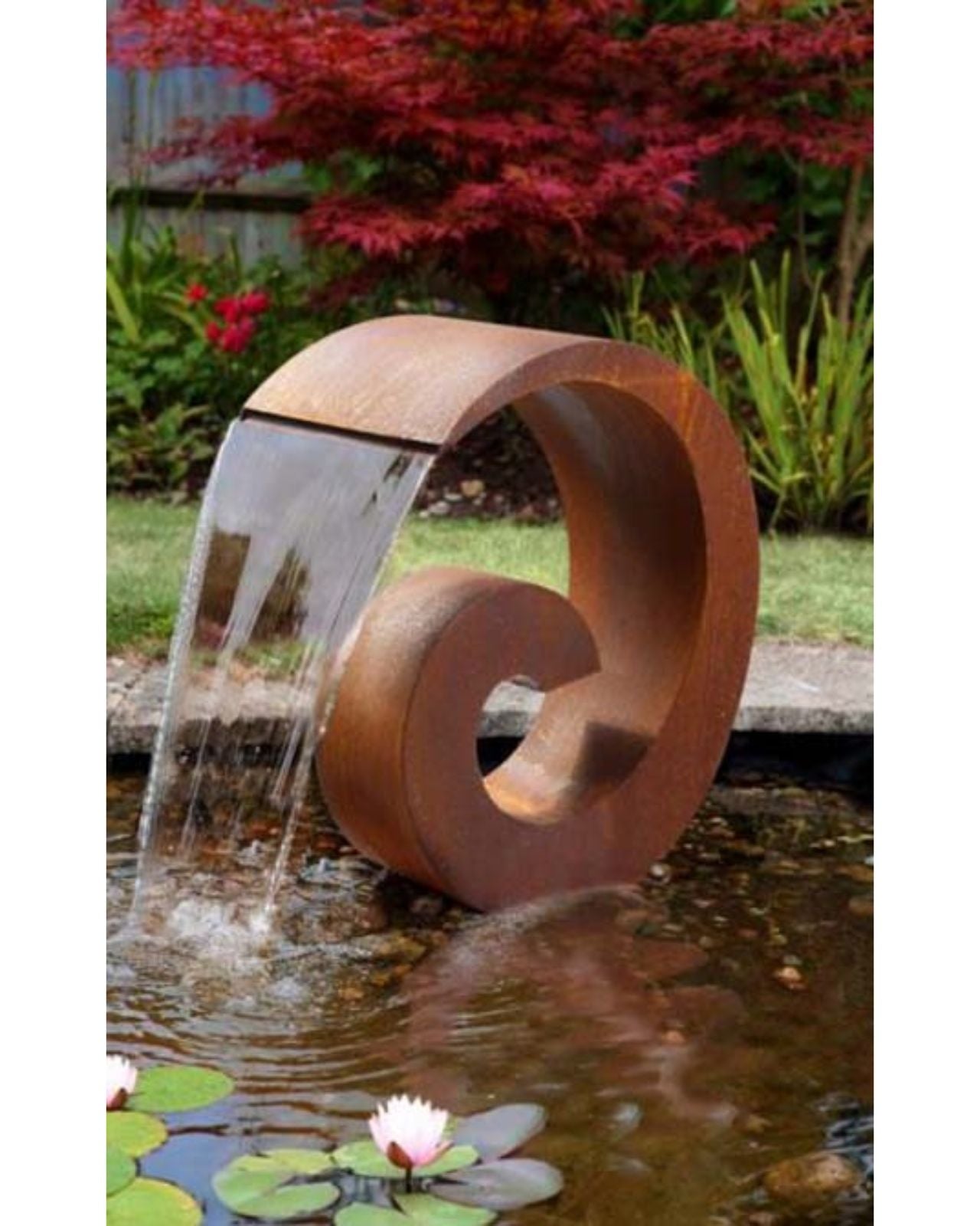Corten Steel spiral water feature in a garden with water flowing into a pond.