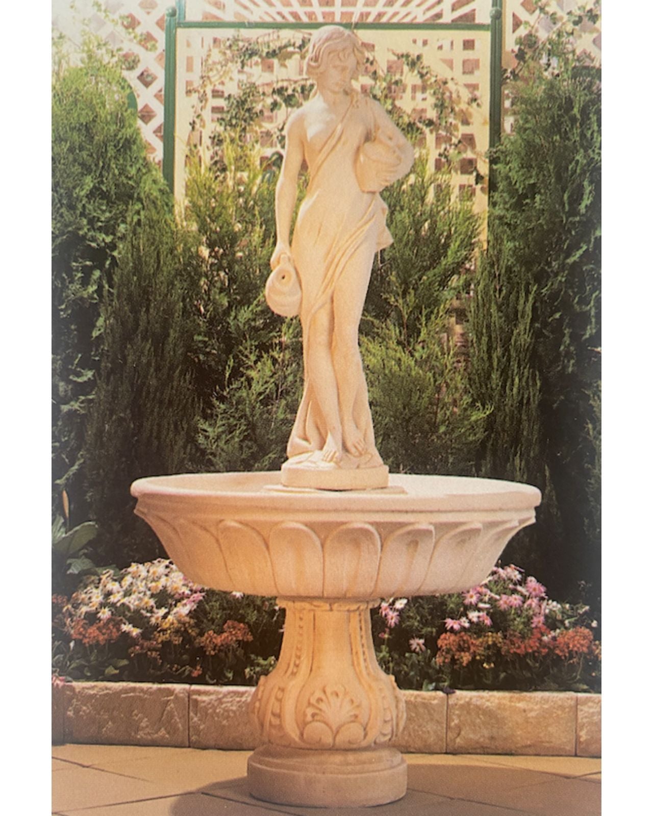White concrete water feature with a sculpted classical figure holding a jug