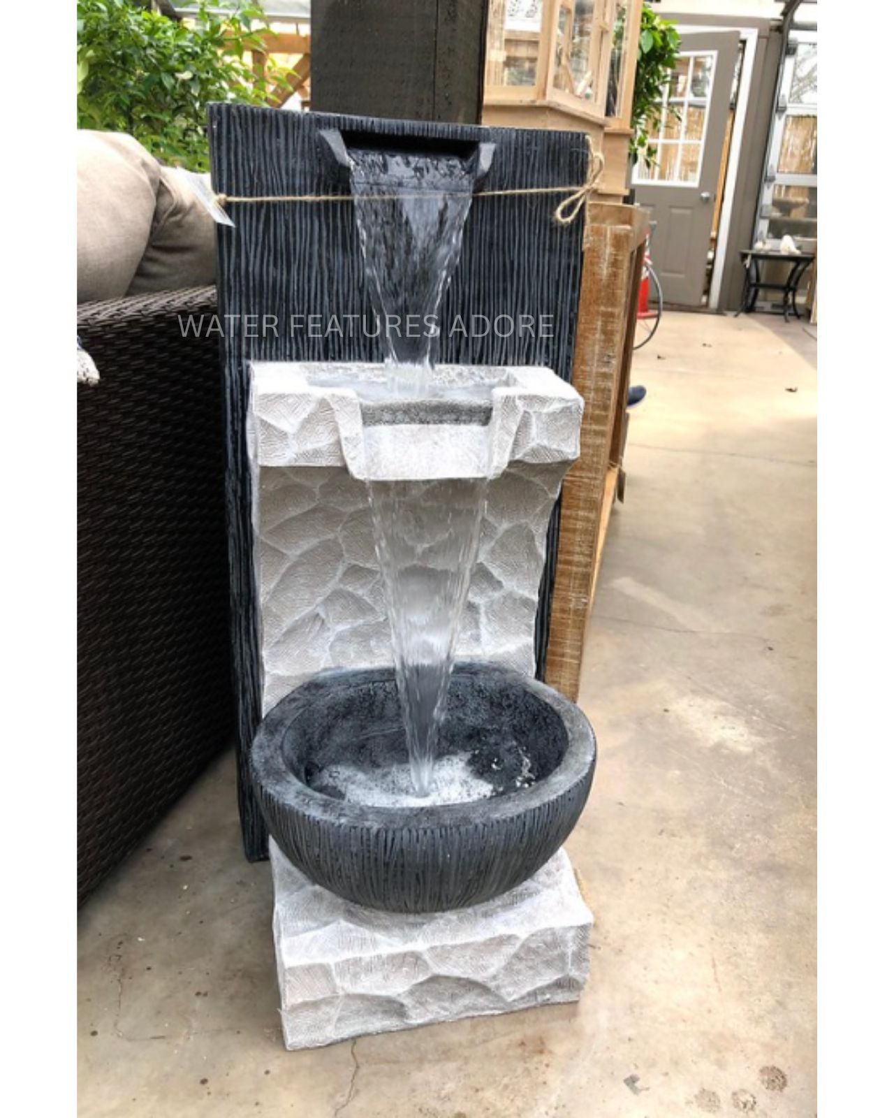 Modern Rustic Rock Texture Tiered LED Wall Water Feature in a backyard