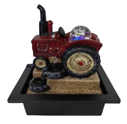 A decorative tractor tabletop water fountain sitting in a shallow black tray with a beige textured base.