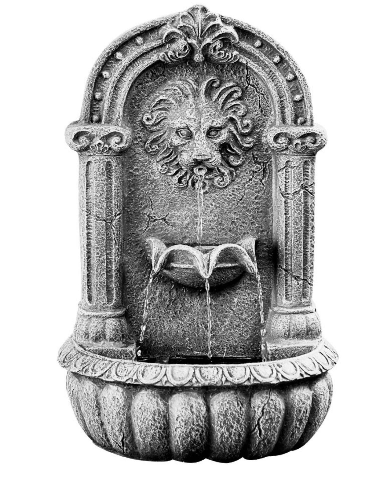 Decorative stone wall feature with lion head design on a white background