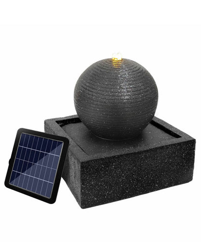 Solar-powered water fountain with a spherical water feature on a white background