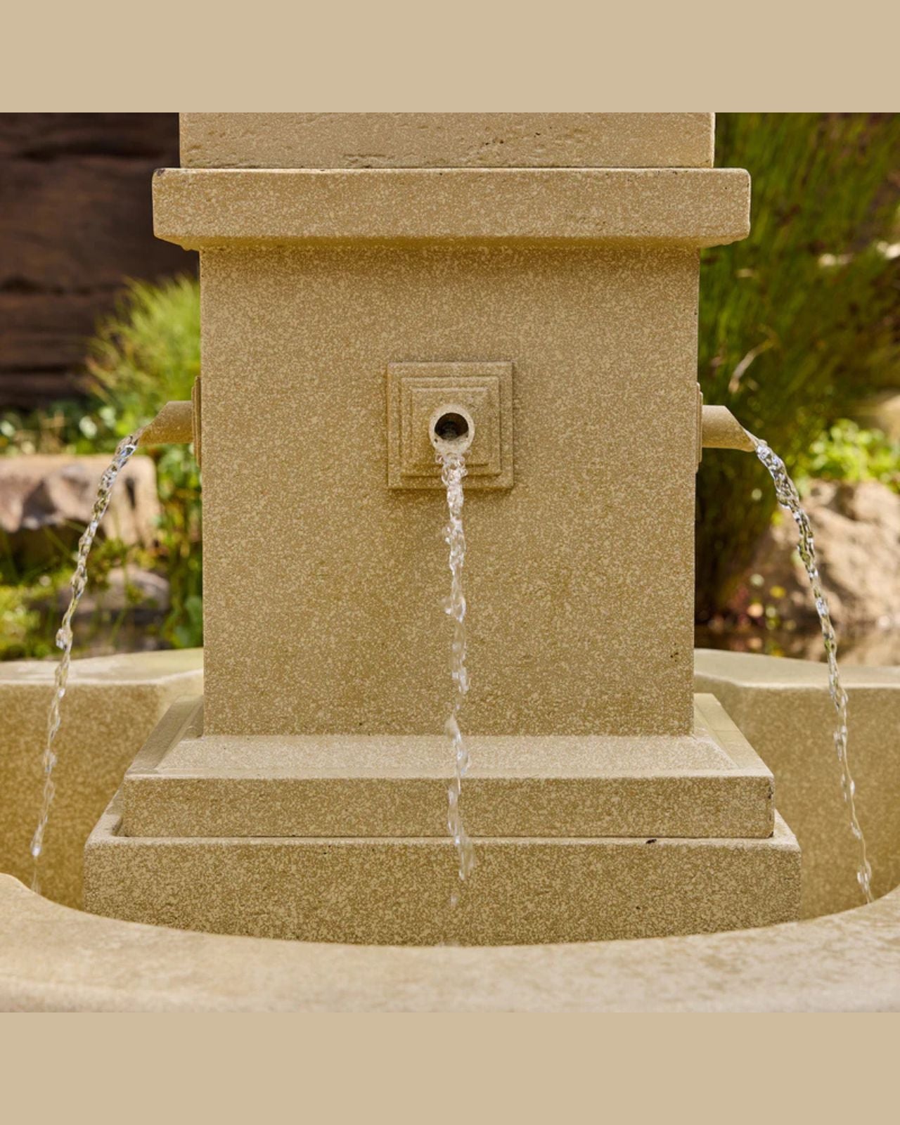 Stone fountain with water flowing in a garden setting