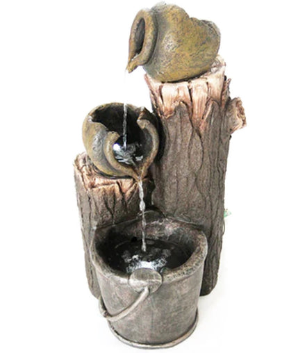 Decorative water fountain with a tree trunk and bucket design on a white background