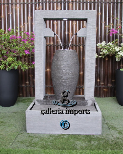 Decorative outdoor water fountain surrounded by plants.