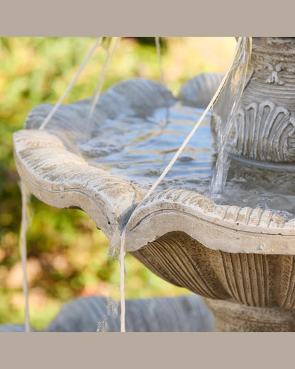 Fleur Stone garden fountain with water flowing in a natural setting