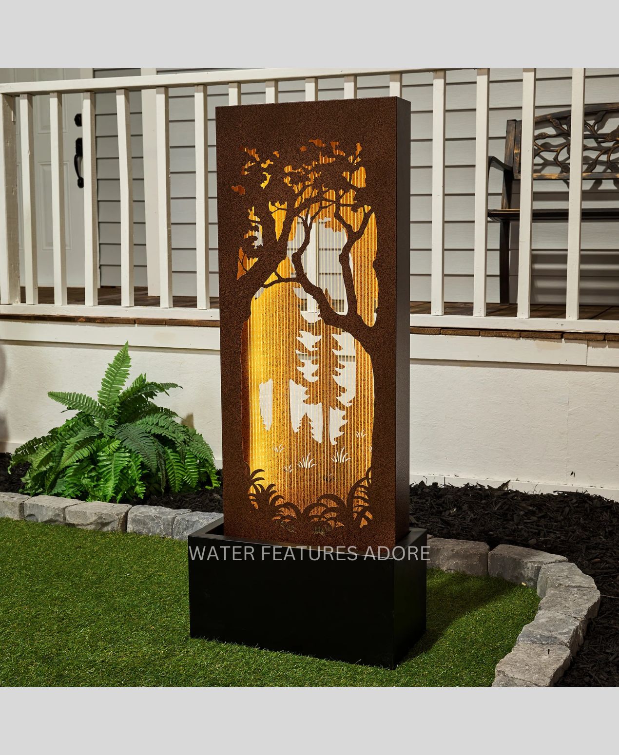 Decorative water feature with tree design in a garden setting