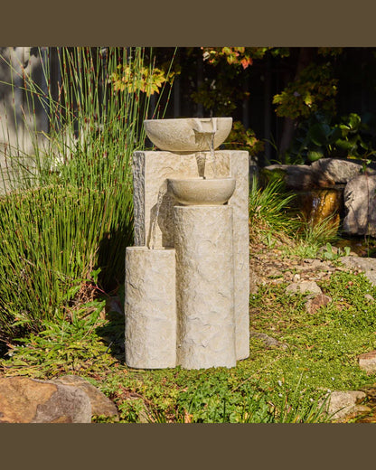Echo Falls Stone garden fountain with three bowls in a natural setting