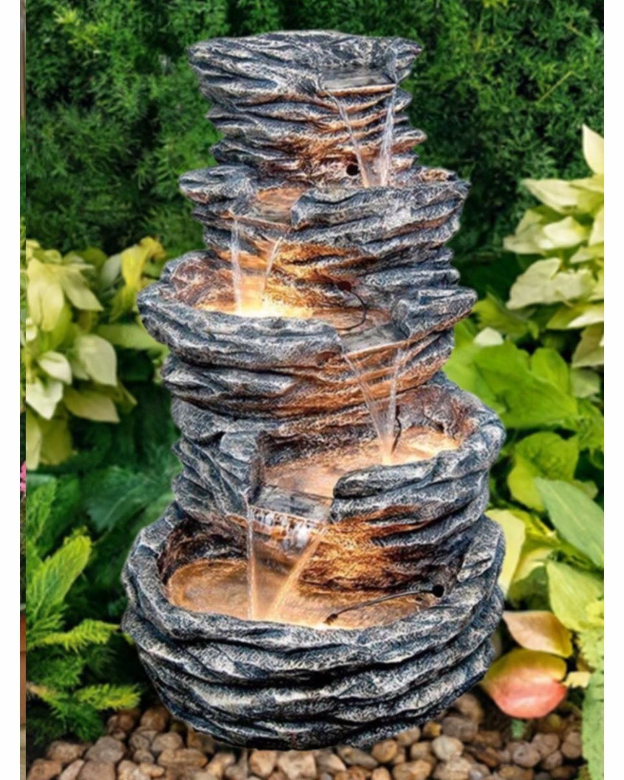 outdoor wooden log water feature surrounded by greenery