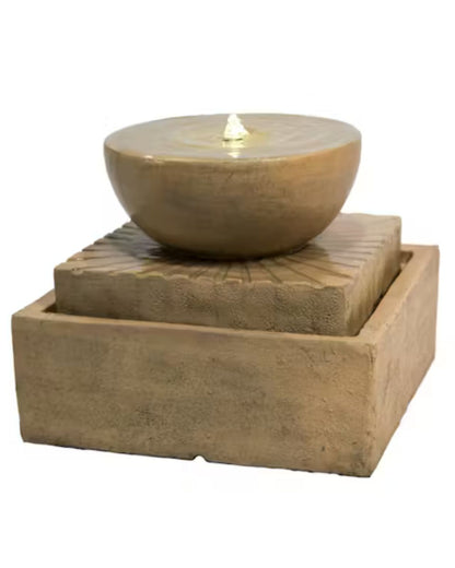 Decorative stone bowl fountain on a square stone base with a white background
