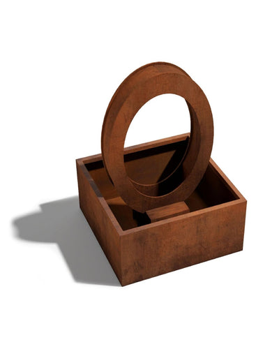 Rust-colored ring water fetaure with a round mirror on a white background