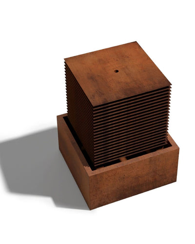 Rust-colored metal box  water feature with a textured surface on a white background