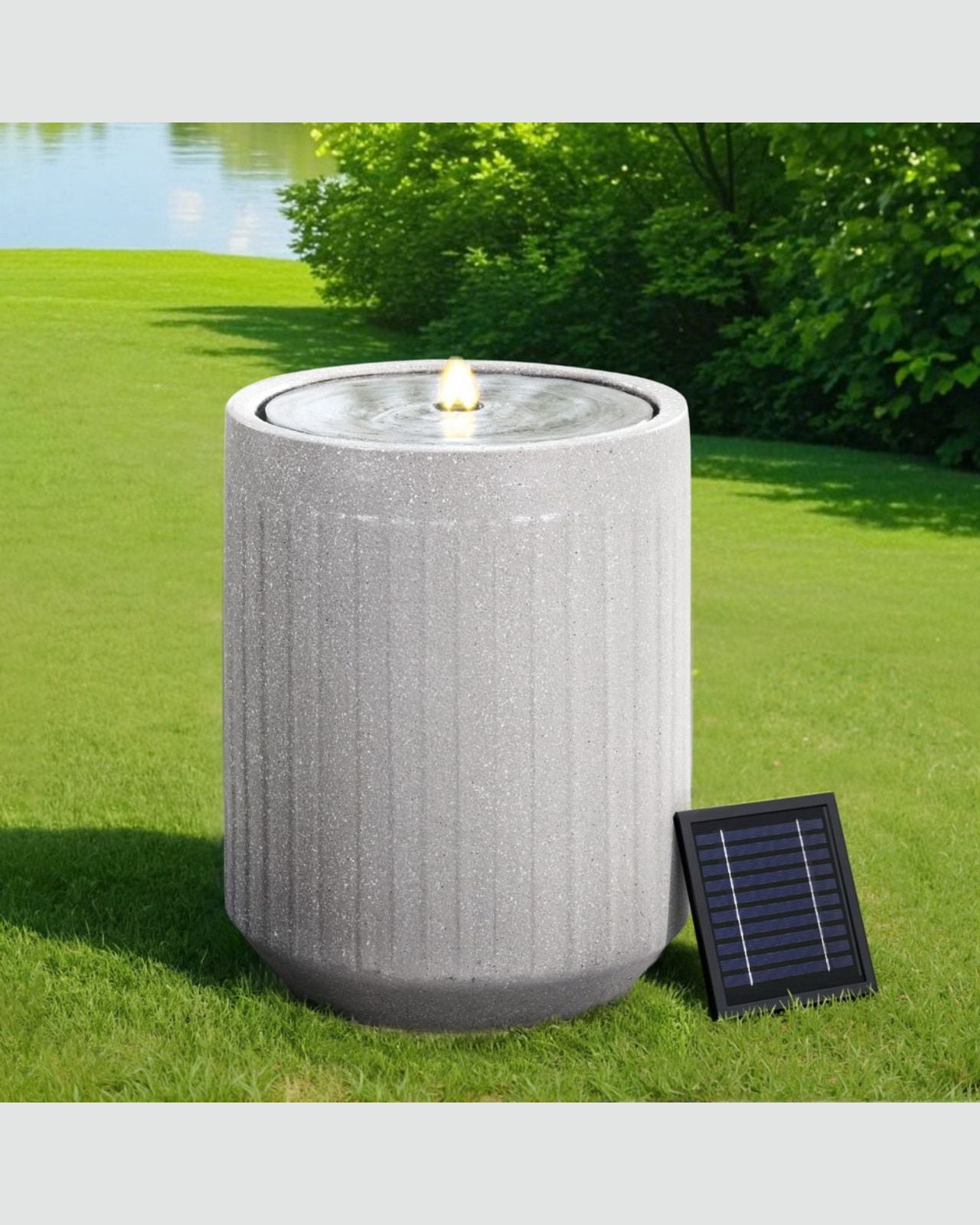Outdoor water fountain with solar panel on grass
