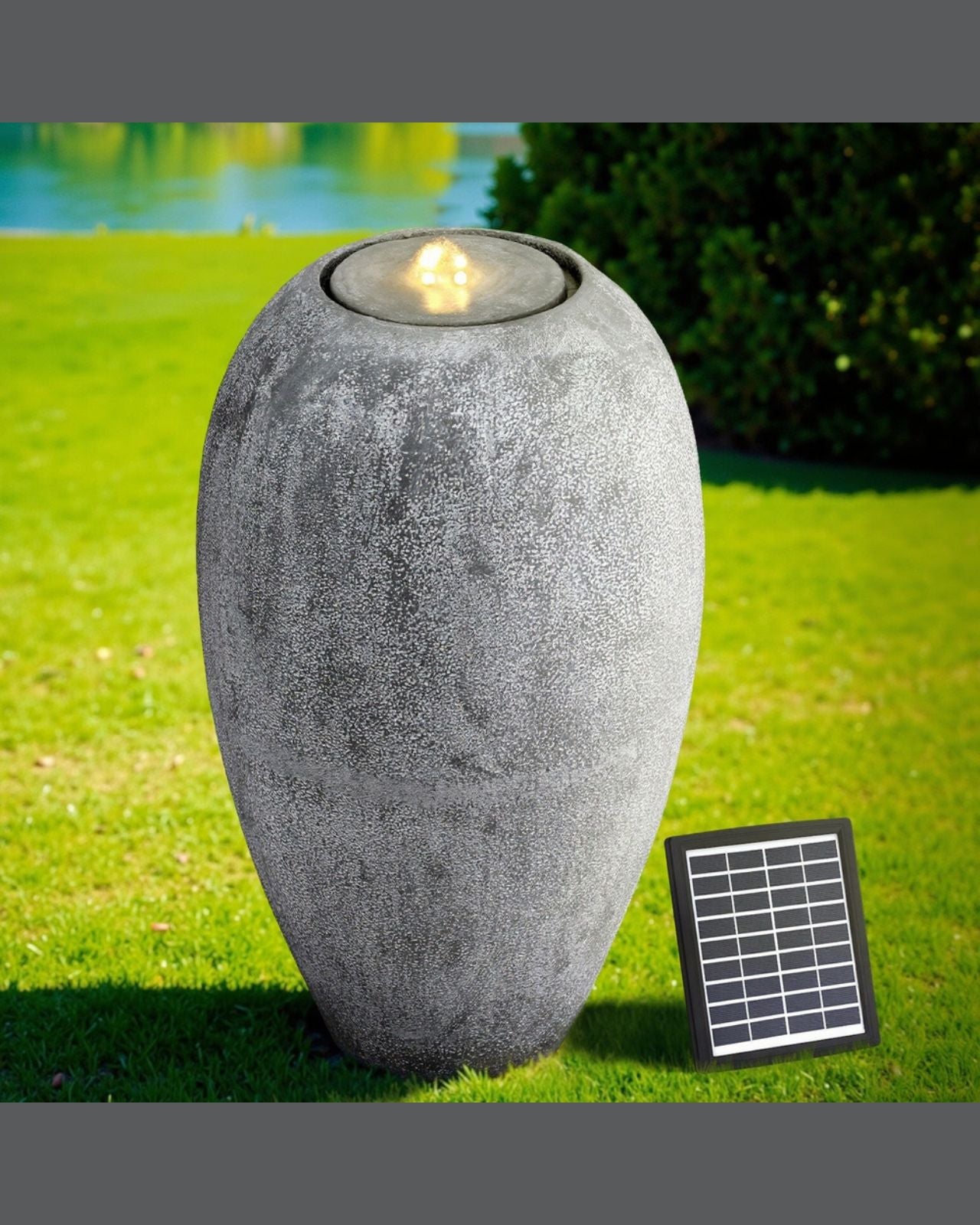 Decorative outdoor vase water feature with solar panel on a grassy area