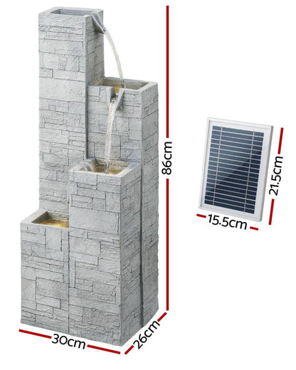 Outdoor water fountain with stone-like design and solar panel, shown with measurements.