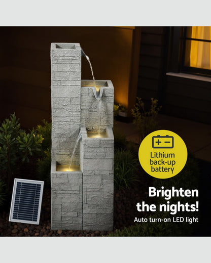 Outdoor water fountain with stone design and solar panel, featuring a lithium-backup battery and LED light.