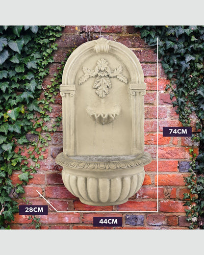 Decorative wall fountain with measurements on a brick wall background