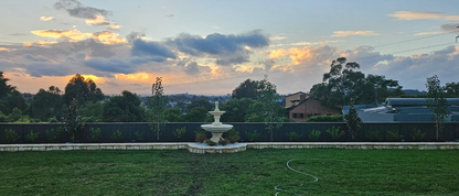 Venezia - 2 Tier Classic Concrete Water Feature in a lush backdrop