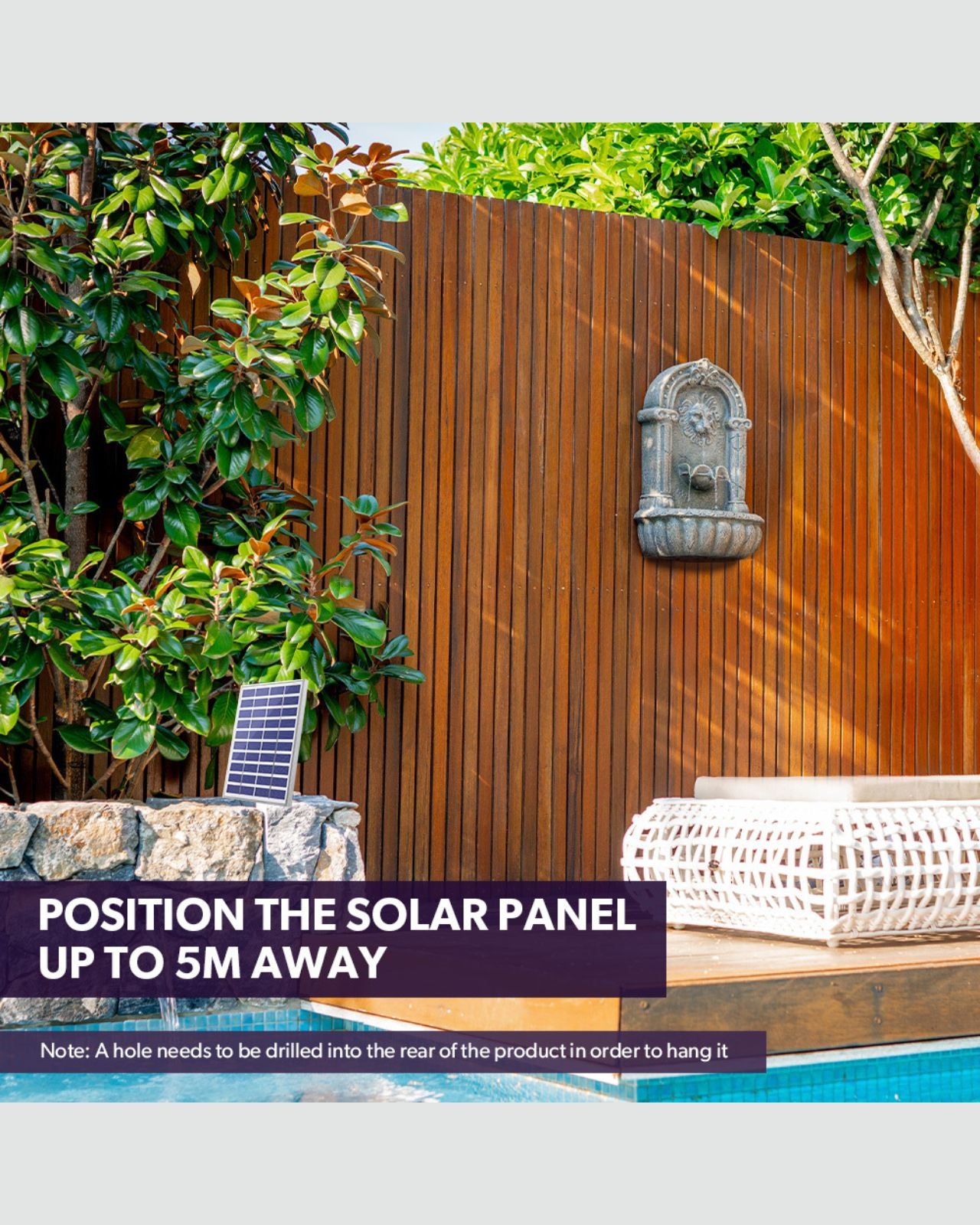 Solar panel with water feature on a patio with wooden fence and garden in the background
