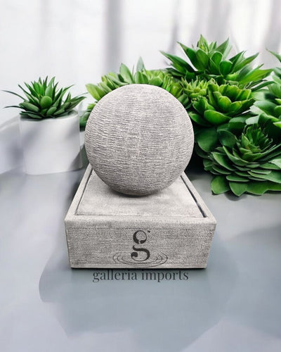 Gray textured sphere water feature on a stand